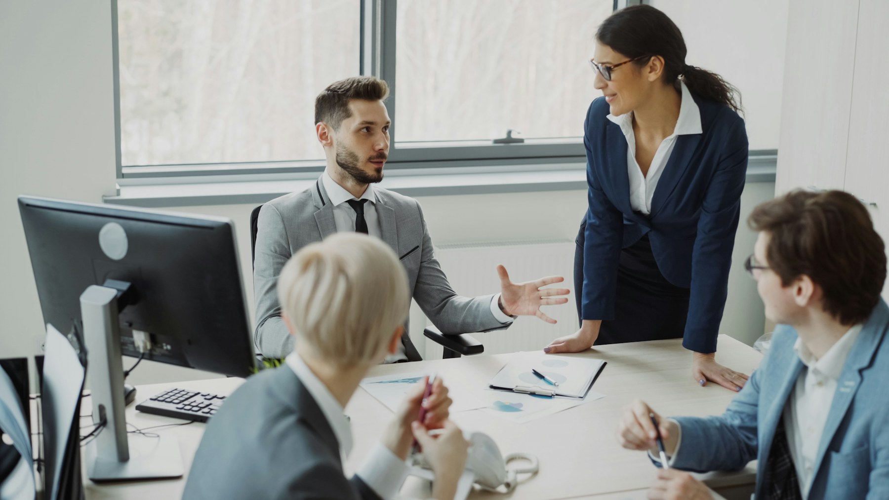 Business professionals discussing strategy around a table